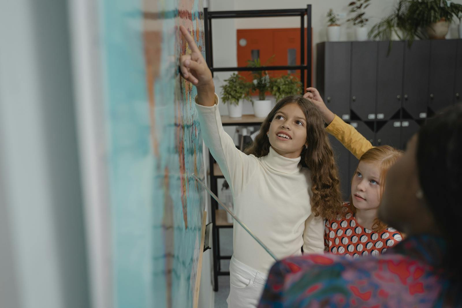 Children actively participate in a geography lesson in a school classroom.