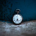 shallow focus photo of silver-colored pocket watch