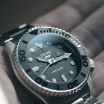 a person holding a watch in their hand